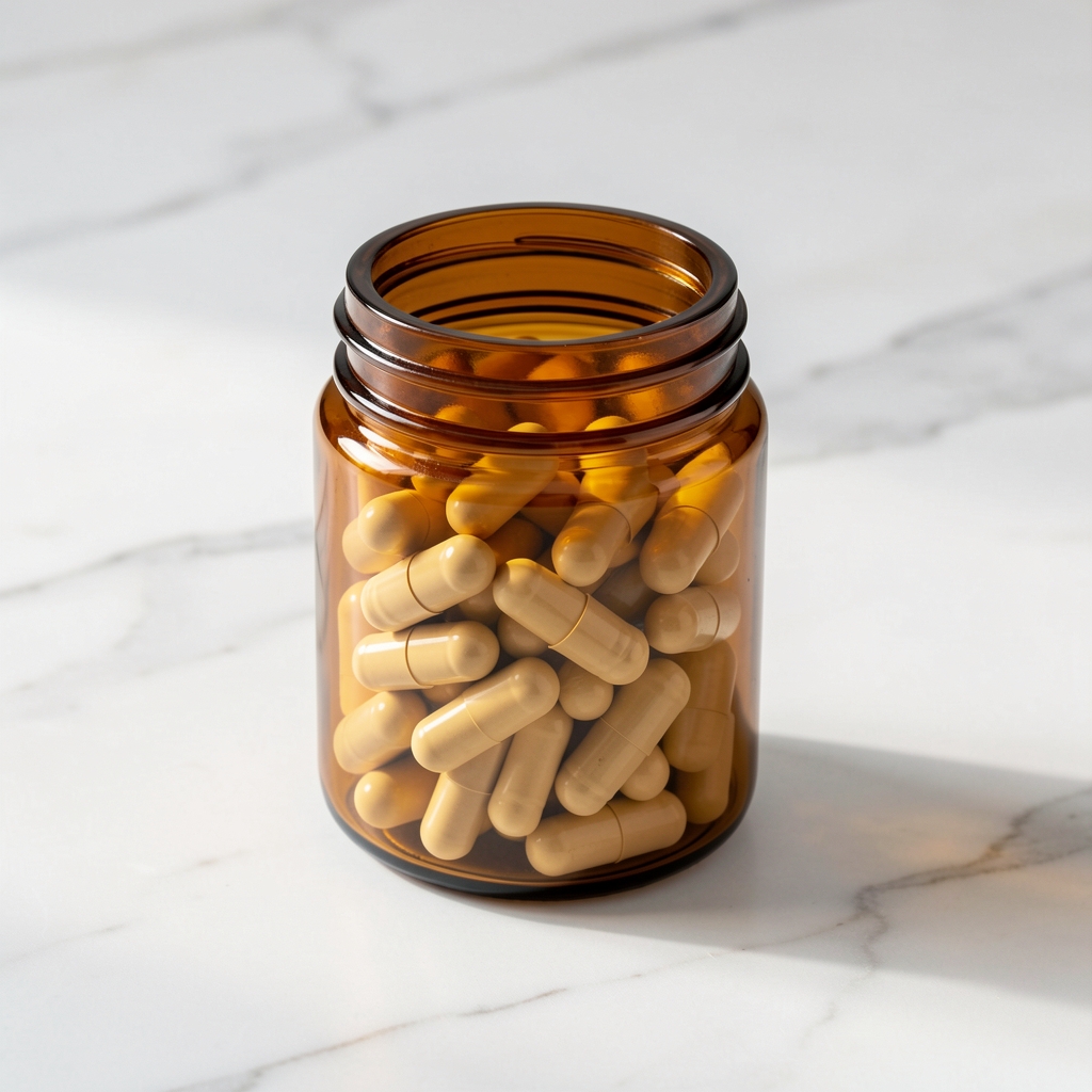 Saltora Foundation supplement capsules in amber glass jar on white marble surface, natural studio lighting